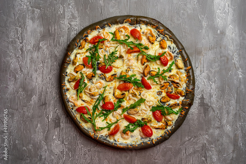 Delicious seafood pizza on light grey table, top view. Space for text