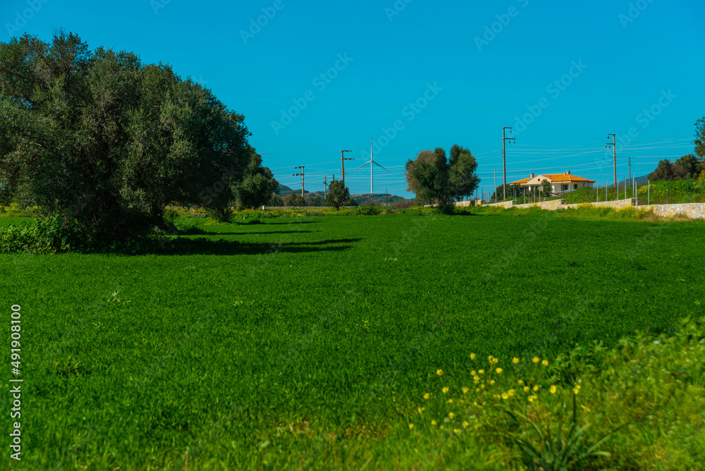 KIZLAN, MUGLA, TURKEY: Fields, mountains and windmills in the the village of Kizlan, near Datca on a sunny day.