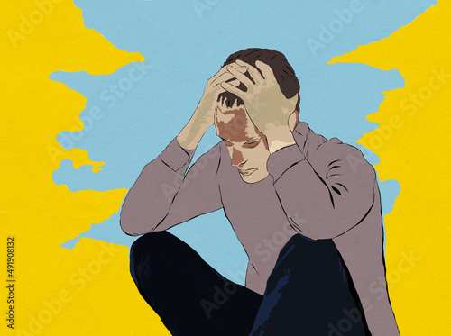 Młody mężczyzna siedzący ręce oparte na kolanach dłonie podtrzymujące głowę niebiesko żółte tło
