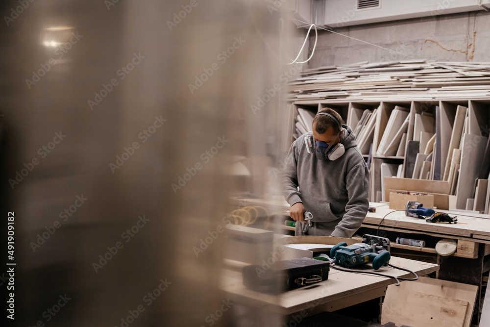 Woodworking carpenter furniture hand cuting. Skills artisan workshop factory. Man in respirator factory industry manufacturer, working workshop, maker construction. Woodworking carpenter furniture hand cuting. Skills artisan workshop factory. Man in respirator factory industry manufacturer, working workshop, maker construction.