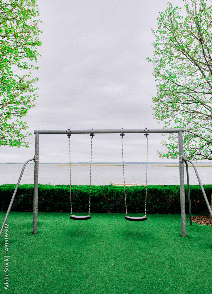 Empty Children swing in the park near sky Empty Children swing in the park near sky