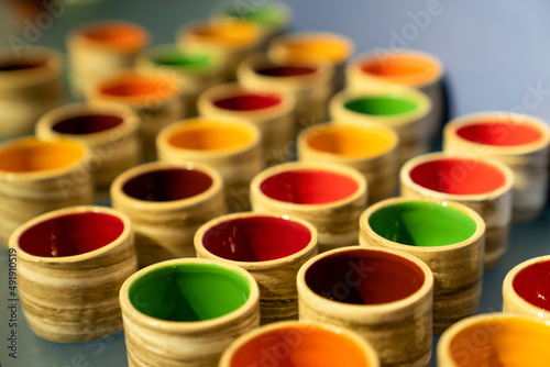 Colorful ceramic cups lined up in a row. Selective focus.