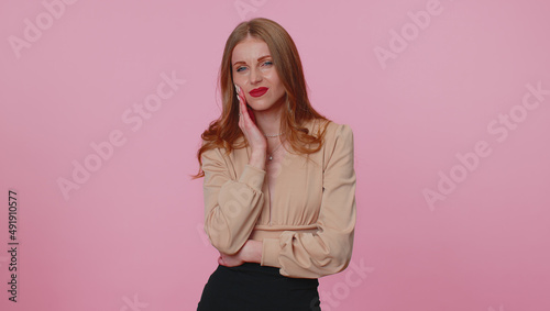 Dental problems. Businesswoman girl touching cheek  closing eyes with expression of terrible suffer from terrible toothache  sensitive teeth  cavities. Young woman isolated on pink studio background