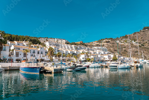View of beautiful harbour "La Herradura". Beautiful bay area situated in Granada province. Luxury yachts docked. Sunny winter day. Luxury real estate.