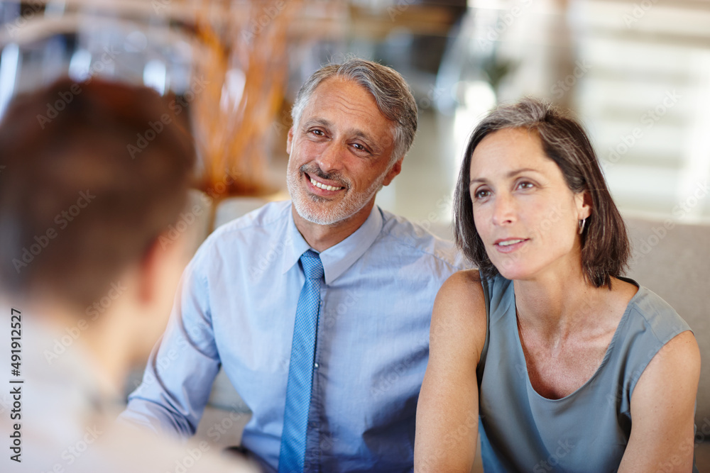 Theyre a great team - in life AND business. A cropped shot of a mid adult couple having a meeting with a young businessman. Theyre a great team - in life AND business. A cropped shot of a mid adult couple having a meeting with a young businessman.