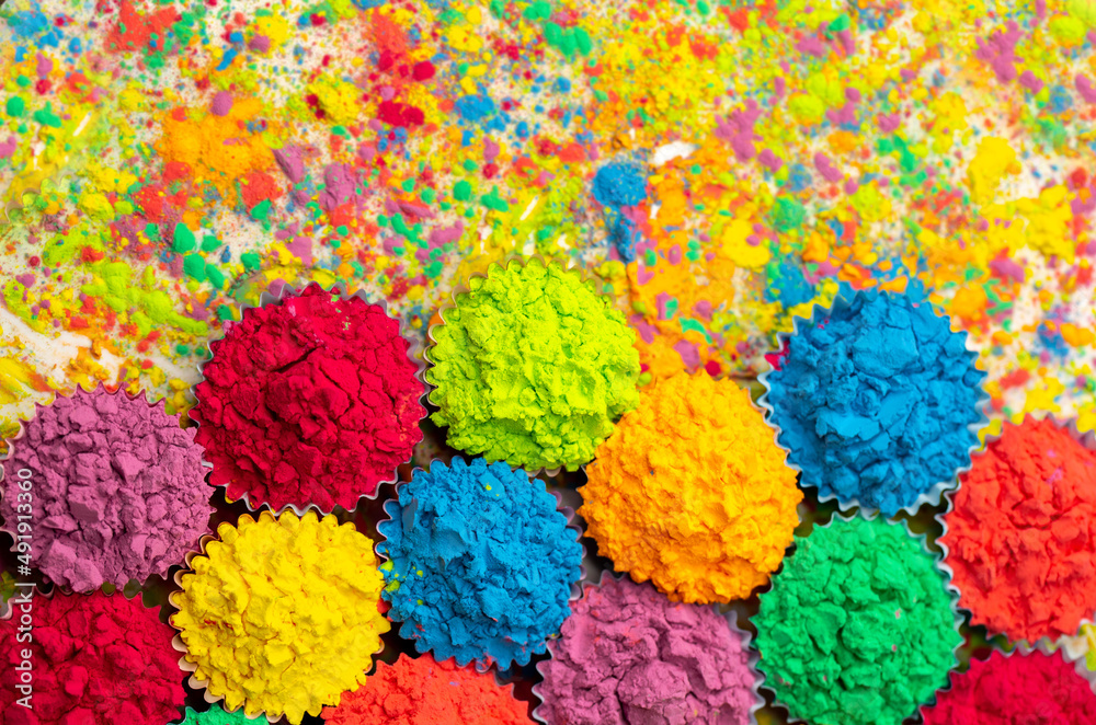 Happy Holi! A colorful festival of colored paints made from powder and dust. Colorful holi powder background. Holiday of bright colors Indian tradition.