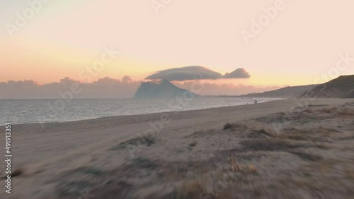 Aerial drone view of the Rock of Gibraltar at sunset from the beach of La Linea de la Concepción, Spain 