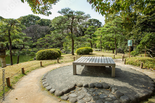 Wooden table or bench (square form) for rest  or  eatong if  you put some heavy object in centre - ther support stone photo