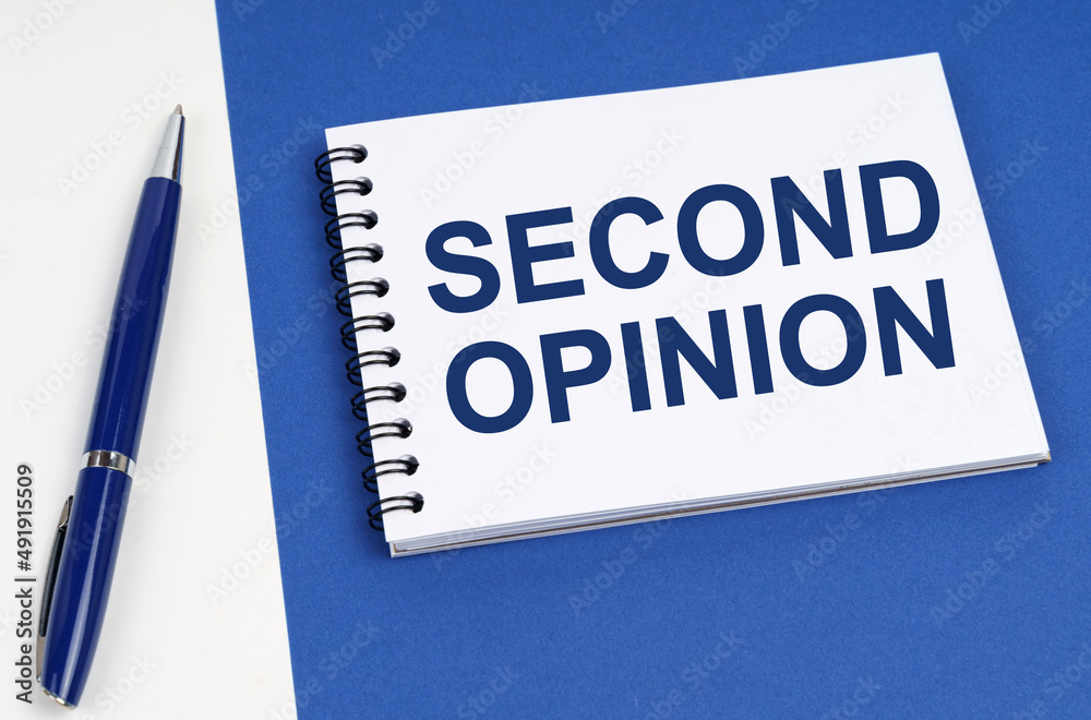 On a blue-white surface lies a pen and a notebook with the inscription - Second Opinion On a blue-white surface lies a pen and a notebook with the inscription - Second Opinion