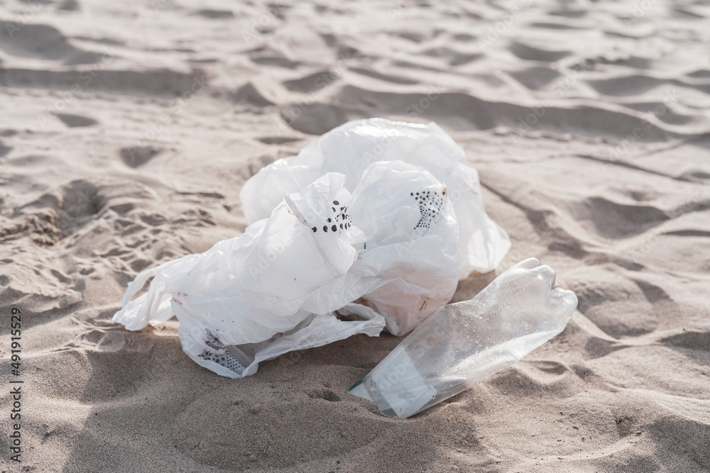 plastic garbage thrown on the sandy coastline on the beach, ecological problem plastic garbage thrown on the sandy coastline on the beach, ecological problem