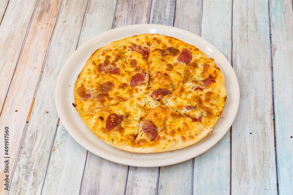 beef mixed and seasoned with paprika or other chili pepper. The pepperoni is characteristically mild, lightly smoked, and bright red in color.