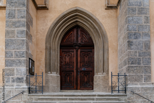 Kutna Hora, Central Bohemian, Czech Republic, 5 March 2022: Gothic stone Church of St. James or Kostel sv. Jakuba with wooden carved arched doors, medieval architecture at old town © AnnaRudnitskaya