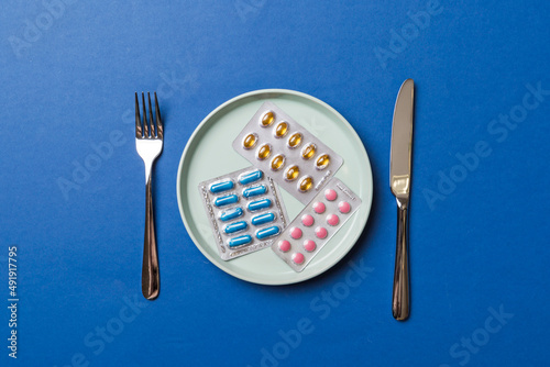 Many different weight loss pills and supplements as food on round plate. Pills served as a healthy meal. Drugs  pharmacy  medicine or medical healthycare concept