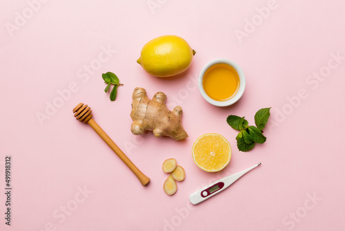 Natural cold and flu home remedies and thermometer. Natural ingredients for immunity stimulation and viruses protection. top view flat lay photo