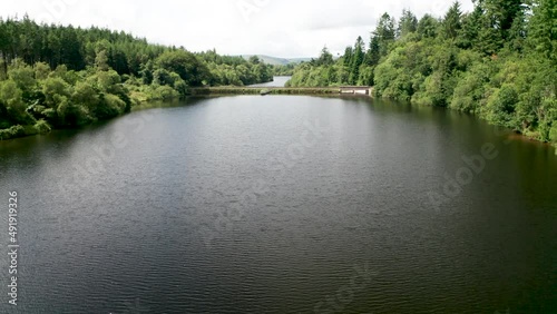 Low angle revealing water catchment reservoirs closely surrounded by woodland