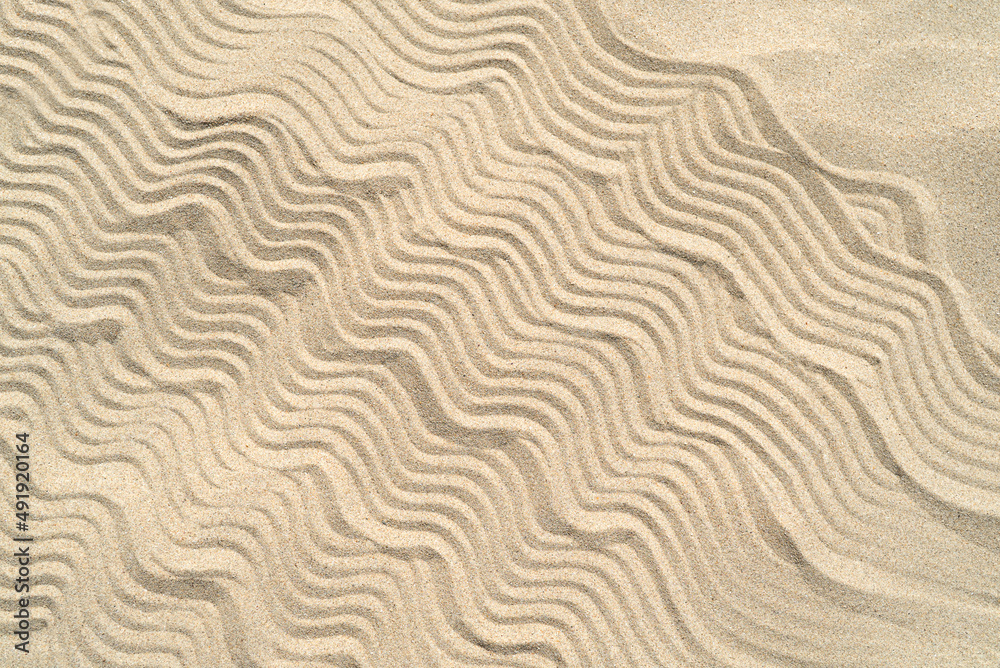 Texture of sea sand background closeup with ornament Texture of sea sand background closeup with ornament