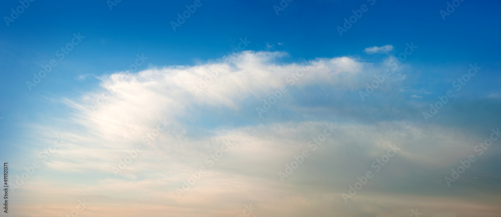 white-orange fluffy clouds in the blue sky, background