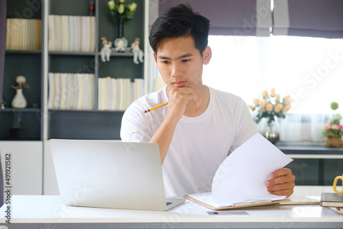 Young man working and learning from home.  photo