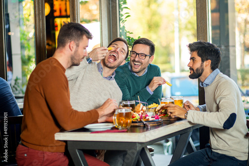 Group of friends enjoying in beer pub
