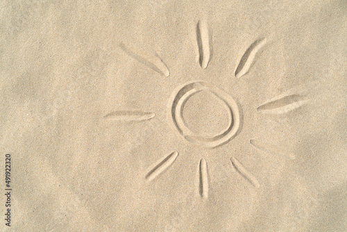 Sun drawn on the sand with copy space,Summer concept