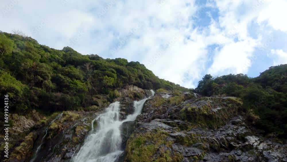 Cinematic shot of ohko no taki waterfall in Yakushima, Japan Cinematic shot of ohko no taki waterfall in Yakushima, Japan