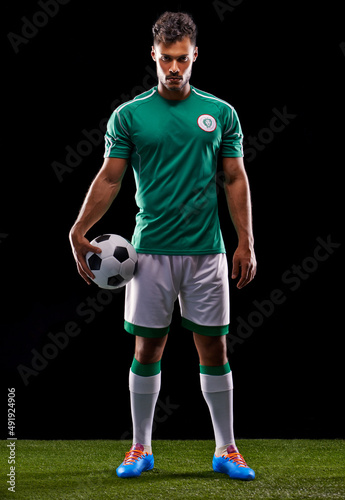 Joga Bonito. Full length studio shot of a handsome young soccer player isolated on black. © Duncan M/peopleimages.com