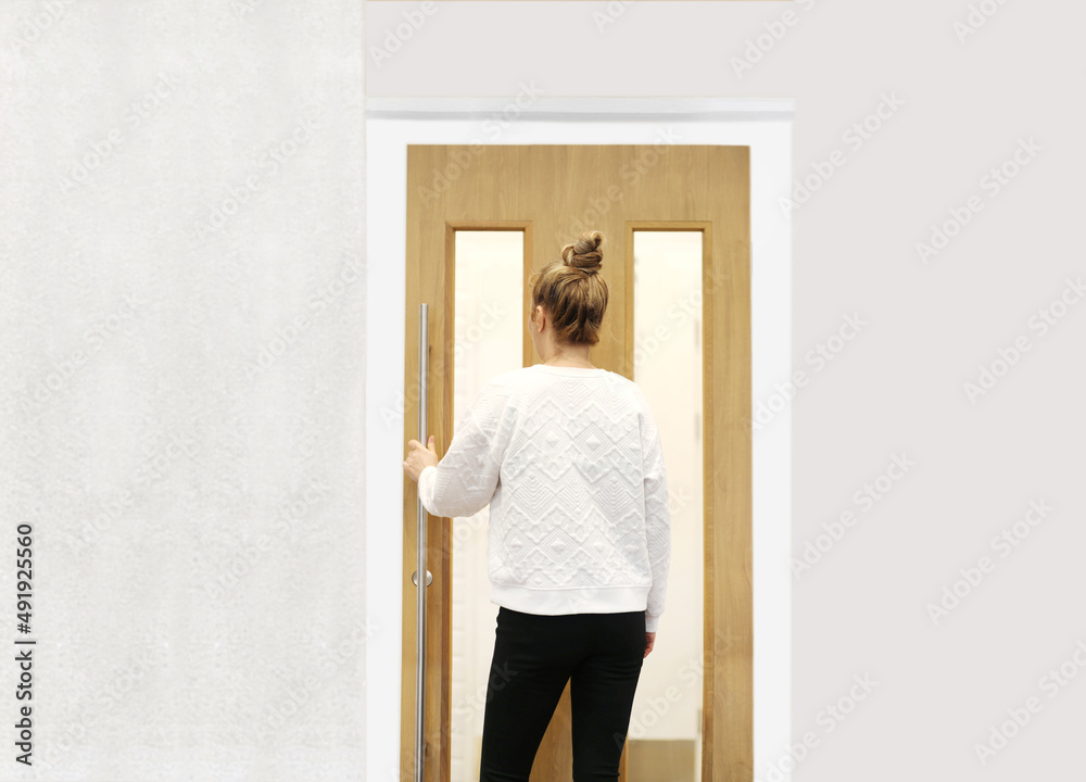 Beautiful woman opening the door of her home. Beautiful woman opening the door of her home.