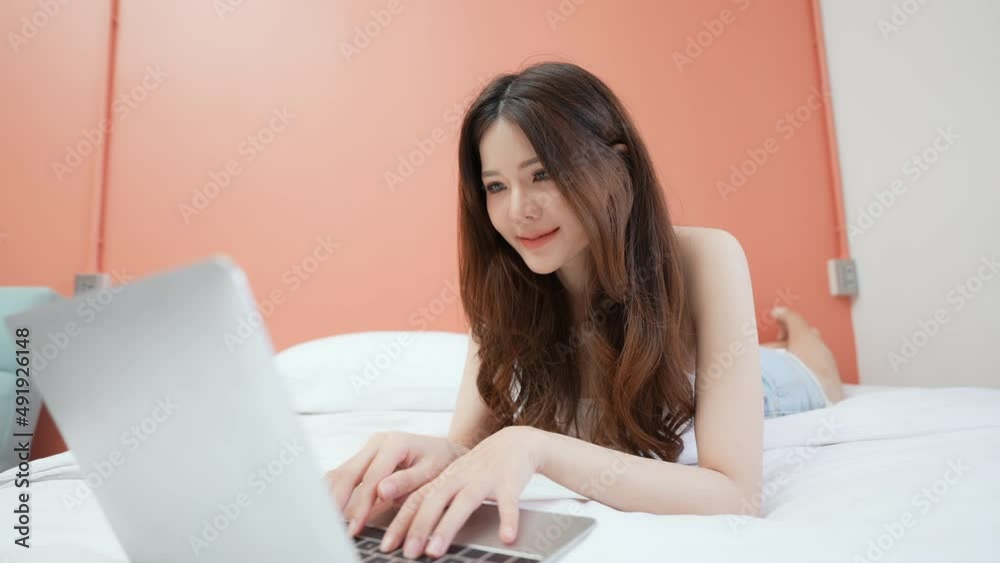 Holiday concept of 4k Resolution. Asian girls working with computers in the bedroom.