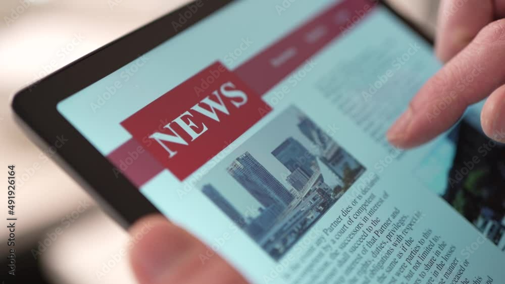 Reading the News Online on a Touch Screen Tablet Closeup Reading the News Online on a Touch Screen Tablet Closeup