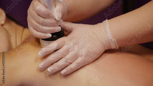 Pretty woman receiving anti-ageing anti-cellulite massage vacuum rf lifting  cosmetic apparatus spa salon. Wellness body  rf skin care tightening  beauty treatment rejuvenation anti-fat procedure