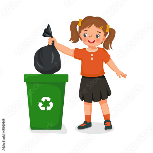 cute little girl taking out the trash in garbage bag into recycling bin. Kids doing daily routine housework chores at home