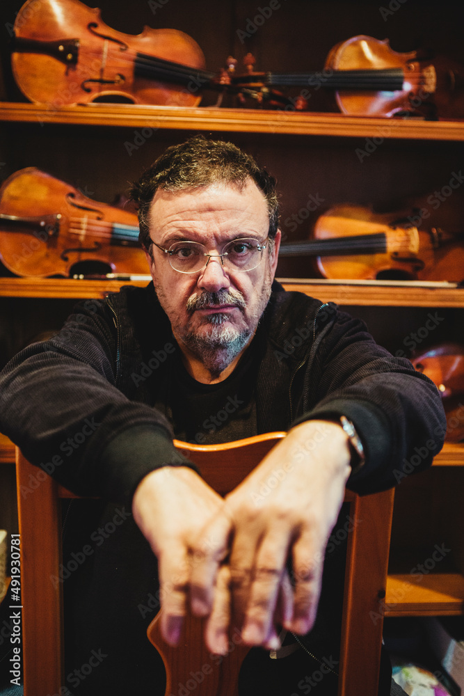 Violin maker (luthier) in his showroom Stock Photo Adobe Stock