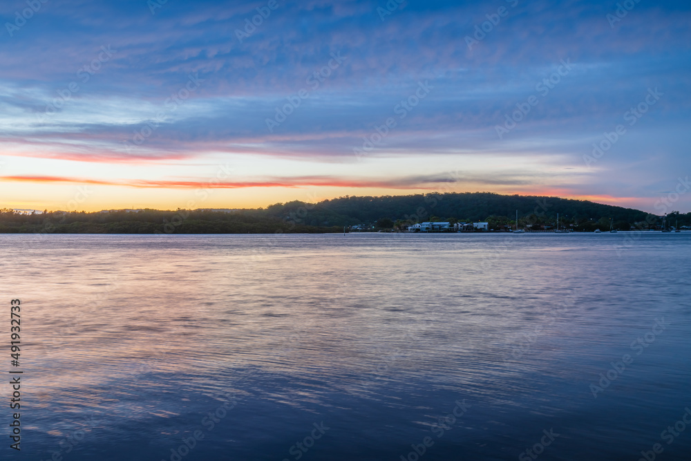 Fototapeta premium Sunrise by the bay with stratocumulus clouds