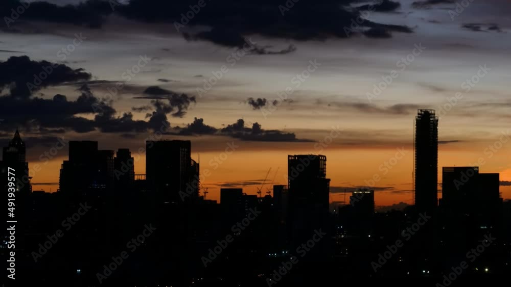 Sunset on city view background, skyline. Dramatic orange color golden dusk sky. Cityscape or landscape, sky meets buildings or landforms. Clouds Sunset on city view background, skyline. Dramatic orange color golden dusk sky. Cityscape or landscape, sky meets buildings or landforms. Clouds