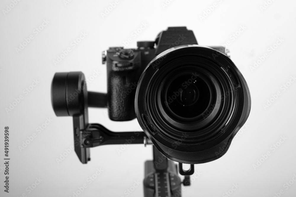 photographic camera in a steadicam on a table with a white background