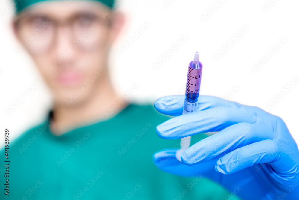 Physician hand with syringe ready for injection, Syringe with medication in doctor's hand. Physician hand with syringe ready for injection, Syringe with medication in doctor's hand.