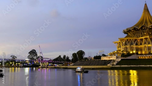 A panning timelapse footage from bright to dark with noise effect Sarawak State Asembly building and other landmark insight. 