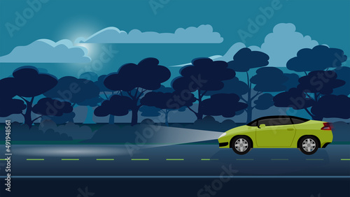 Traveling of sport car yellow color driving on the asphalt road on night time. Turn on the headlights and the light hits the ground. ฺBackgroun of trees forest under night sky with moon and clouds.