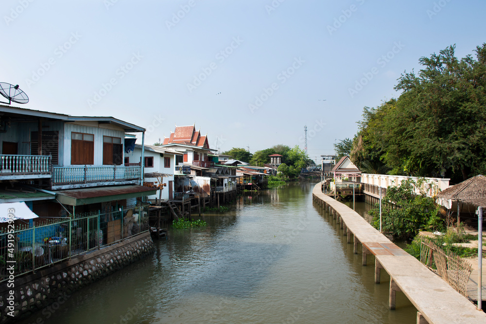 Life lifestyle of thai people at chaopraya riverside and water drainage door in fishing village for travelers visit at Sam Khok waterfront at Pathumthani on March 5, 2022 in Pathum Thani, Thailand
