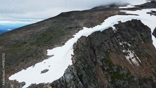 Wild and rugged mountain peaks surrounding Crater Lake in Britsih Columbia, Canada. Sweeping wide angle aerial shot photo