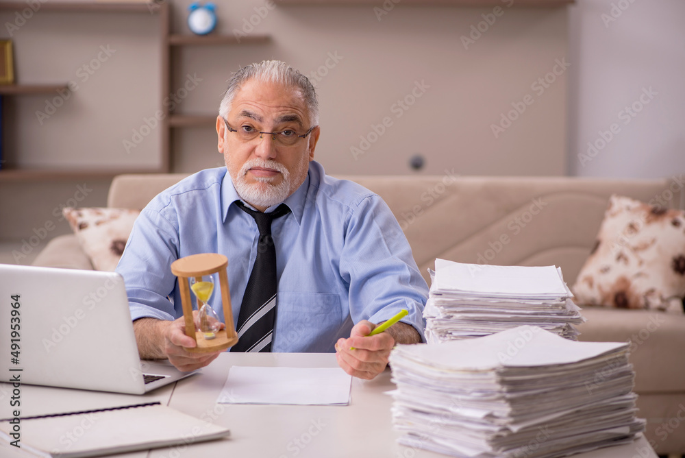 Old male boss working from home during pandemic Old male boss working from home during pandemic
