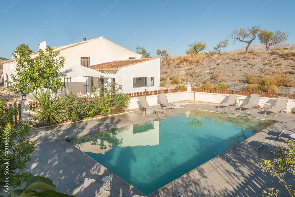 Fototapeta premium A rural hotel with swimming pool on a hill
