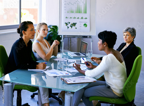 Discussing business strategy. Shot of four businesswomen during a business meeting.