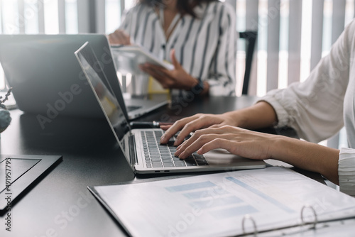 Wallpaper Mural Teamwork process, business people working pointing laptop computer and discussing documents and idea at meeting. Torontodigital.ca
