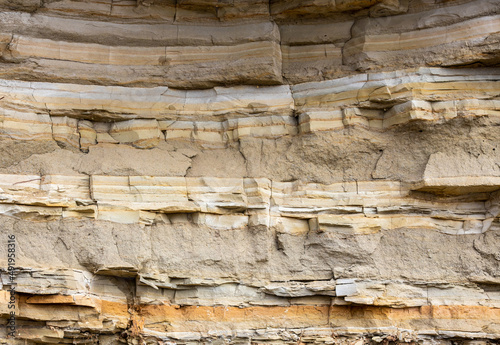 Geological layers of earth - layered rock. Close-up of sedimentary rock photo