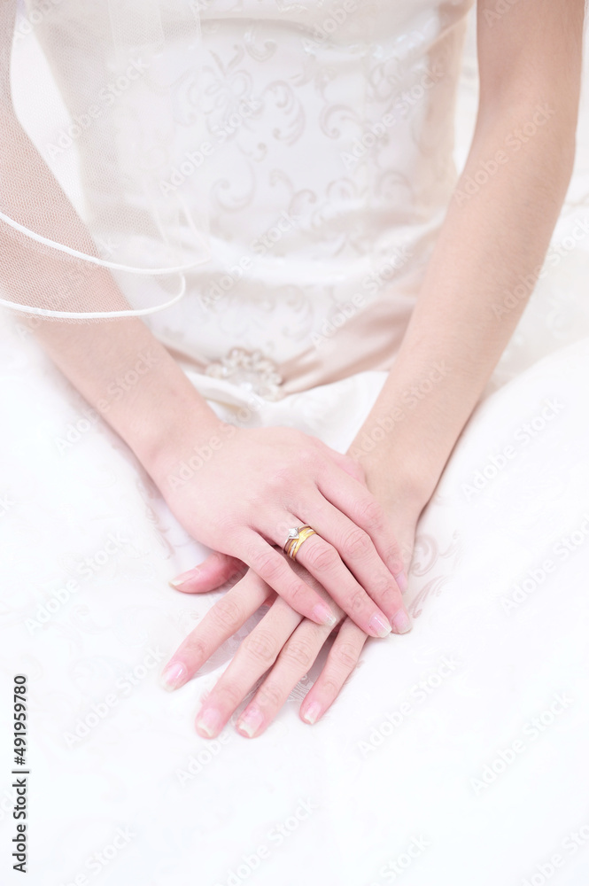 a bride with her hands place on her lap during a wedding