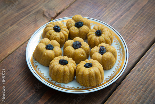 Traditional oriental sweet dessert zhent with raisins in a plate on a wooden background  photo