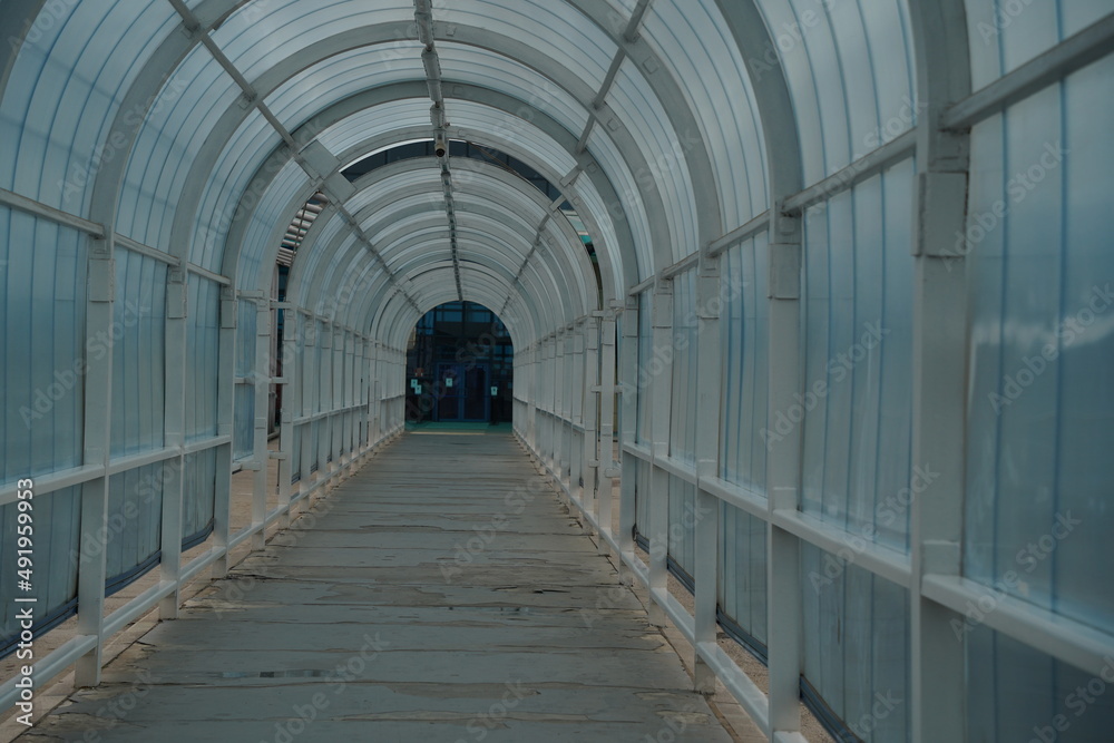 Almaty, Kazakhstan - 05.20.2021 : Tunnel passage to the airport with a glass arch.
