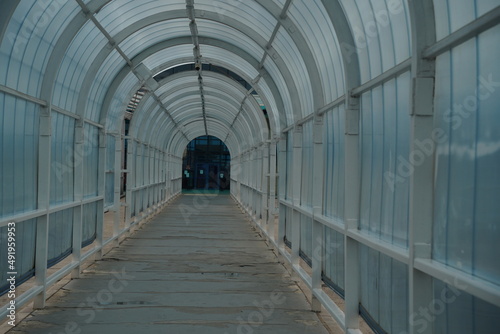 Almaty, Kazakhstan - 05.20.2021 : Tunnel passage to the airport with a glass arch.