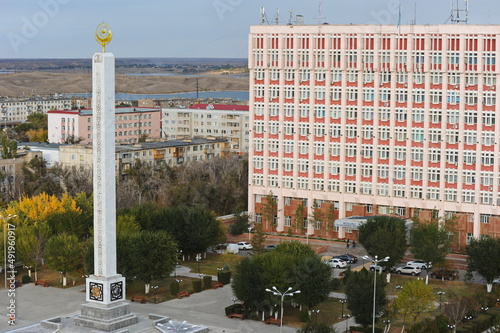 A stele with state symbols in the central part of the city photo